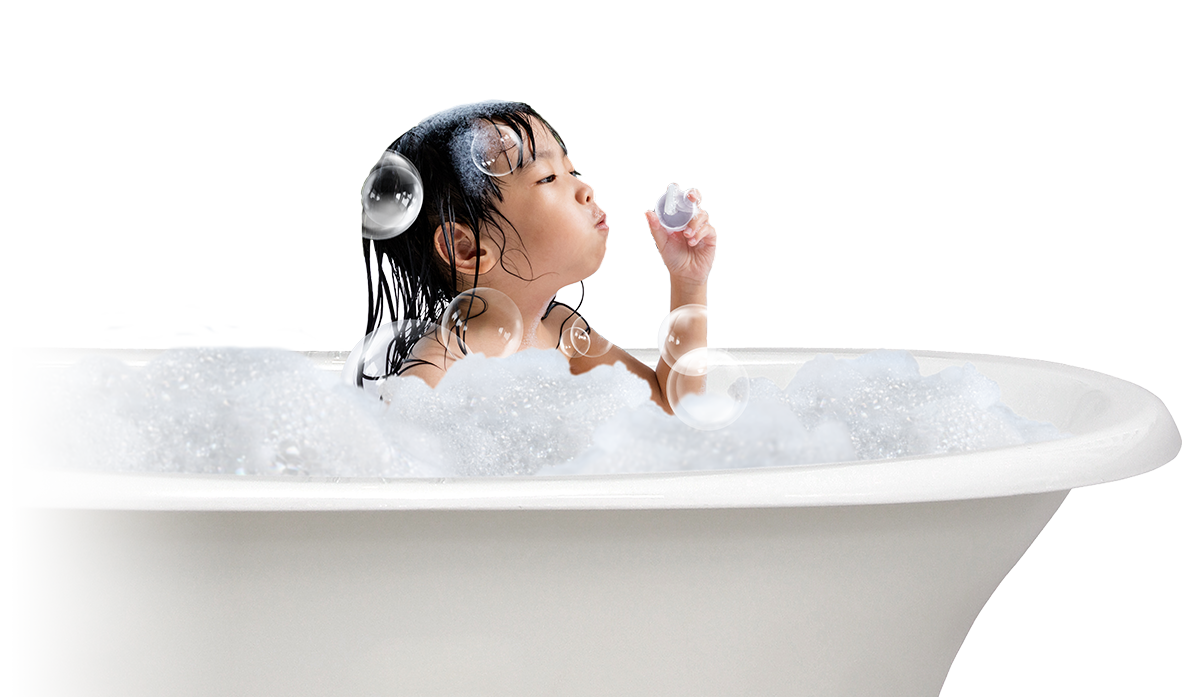 Girl in bathtub blowing bubbles